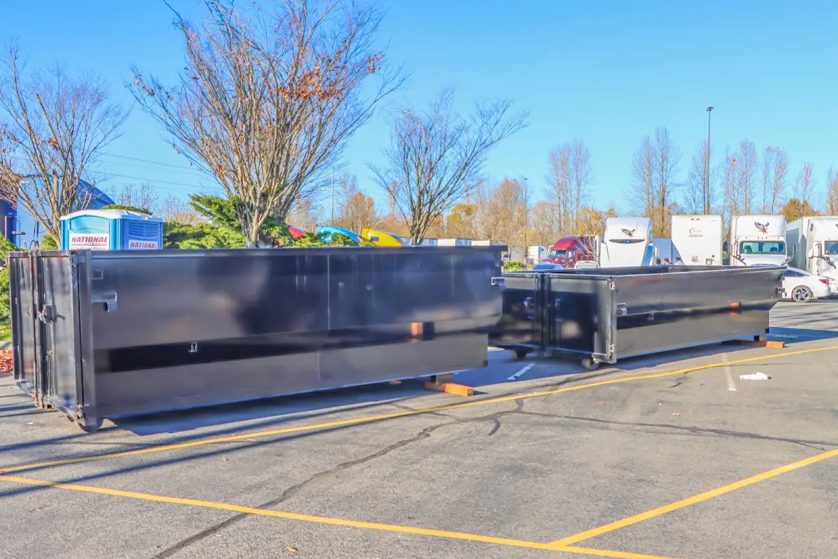 Professional dumpster rental service with roll-off container on residential driveway in Valle Vista